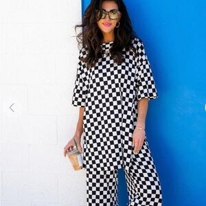 Dressed in LALA Black and White Jumpsuit with Wide Legs and Short Sleeves